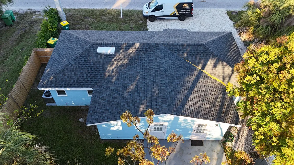 Blue House Roof Project - Jacksonville FL Aerial view of blue house roof replacement project Jacksonville FL