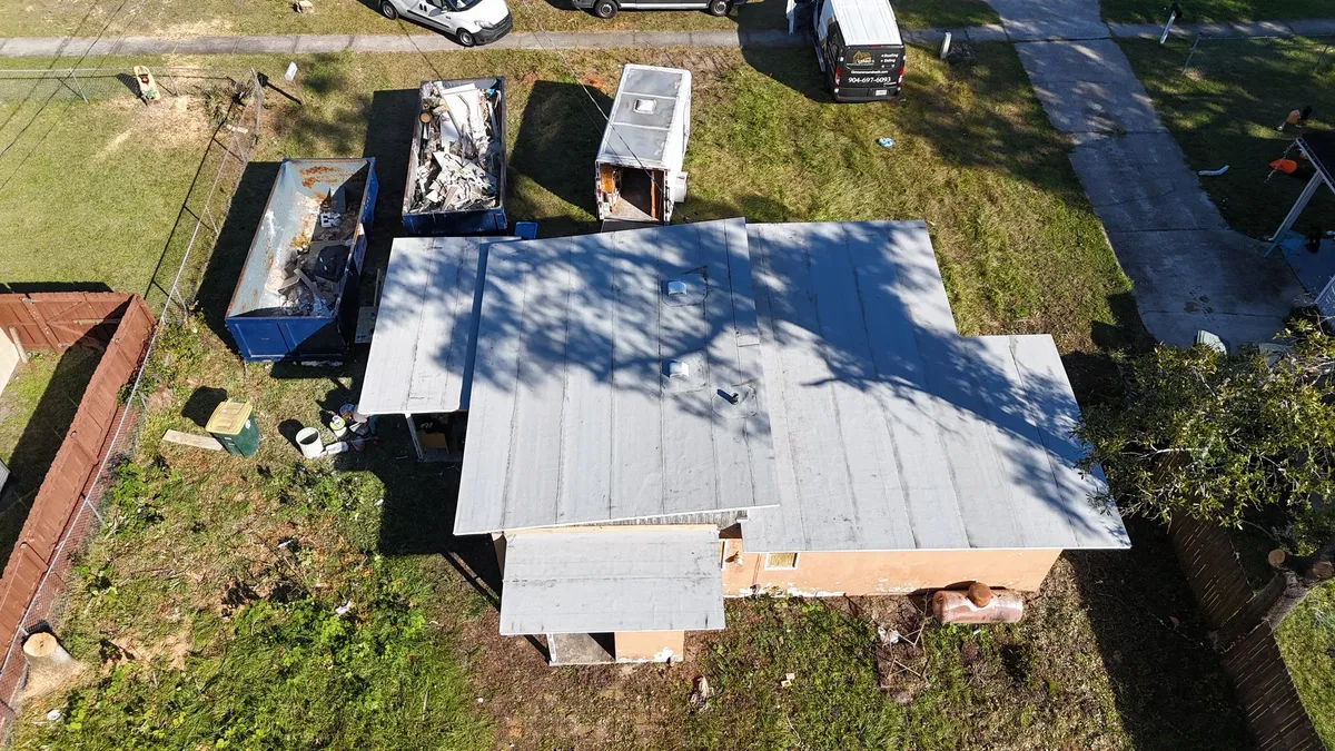 Metal roof construction in Jacksonville FL Metal roof panels being installed at a Jacksonville FL construction site